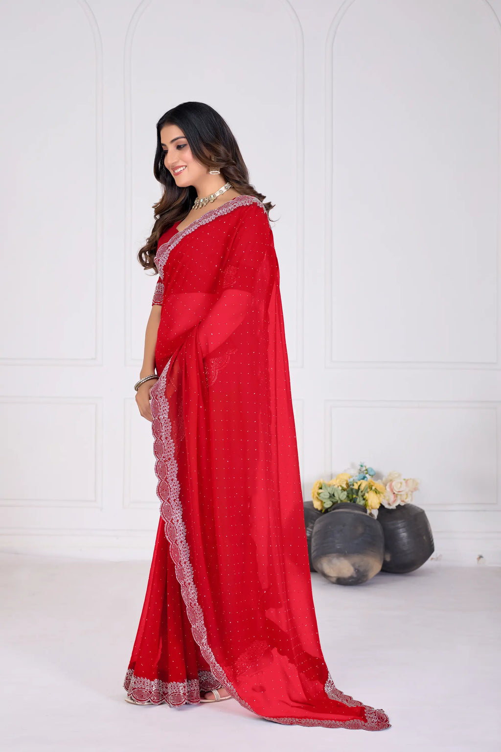 Woman wearing a red saree with a white background